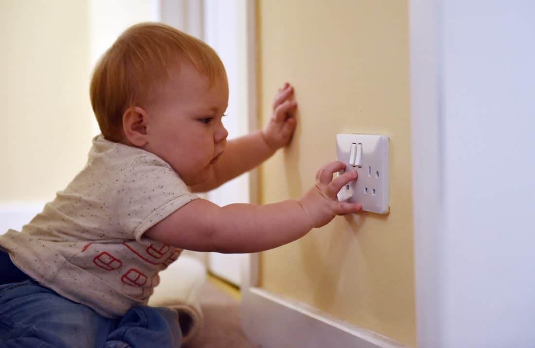 baby playing with electrical power point