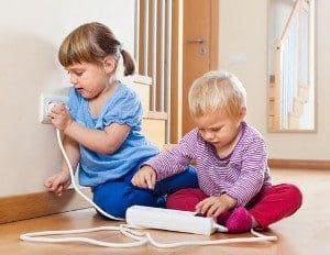 two children playing with electric power point