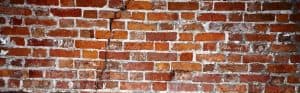 close up of cracked clinker brick wall
